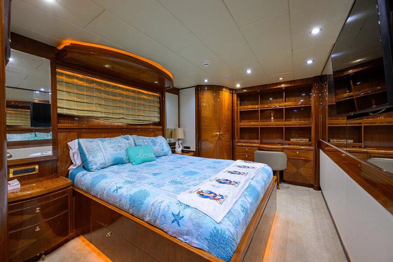 a bedroom with a bed and a chair aboard DUNIA Yacht for Sale