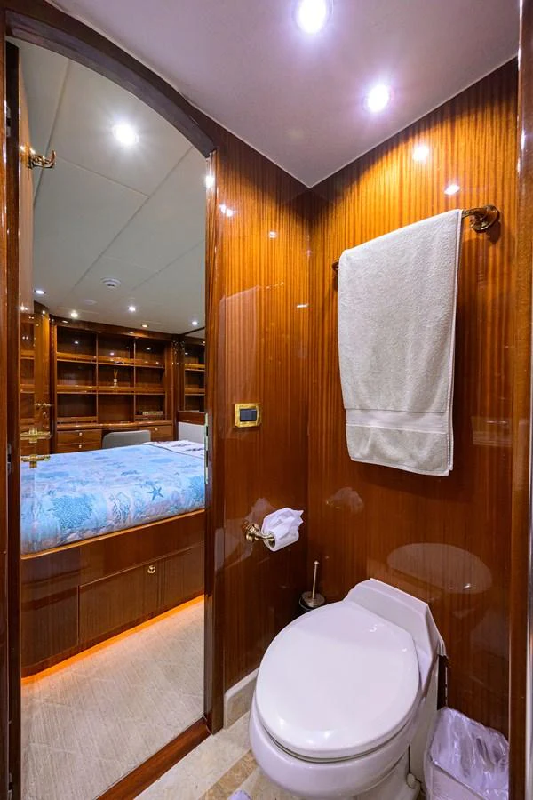 a bathroom with a toilet and a mirror aboard DUNIA Yacht for Sale