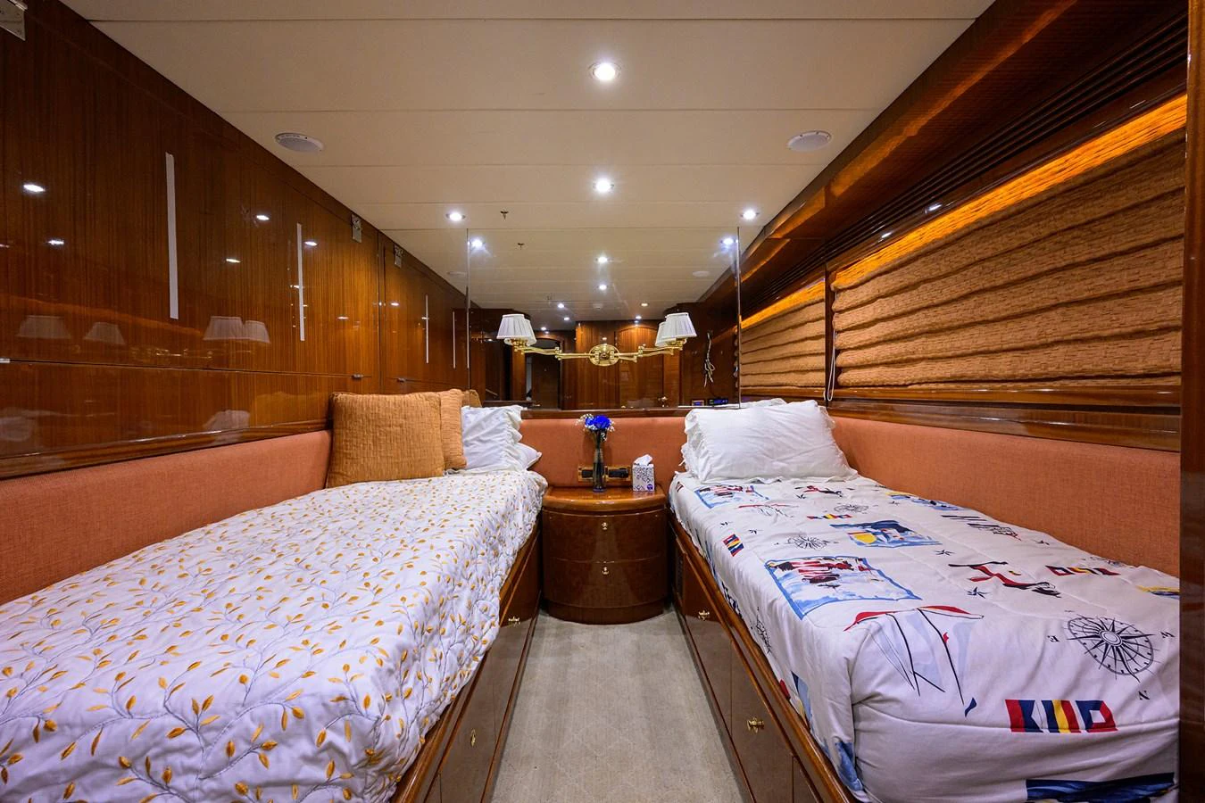 a room with beds and a table aboard DUNIA Yacht for Sale