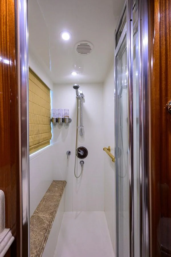 a shower with a sink and a mirror aboard DUNIA Yacht for Sale