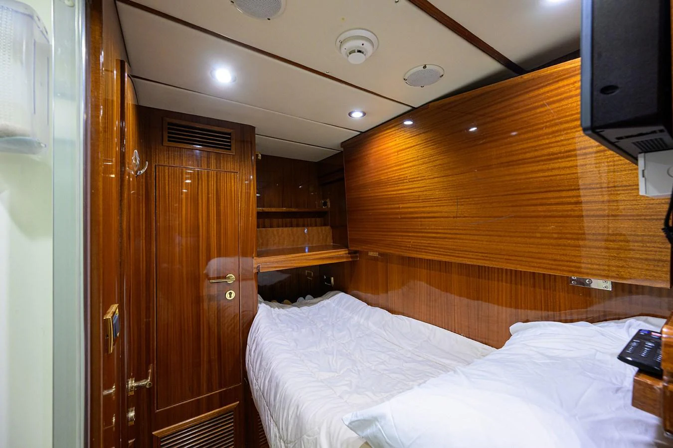 a room with a bed and a wood door aboard DUNIA Yacht for Sale