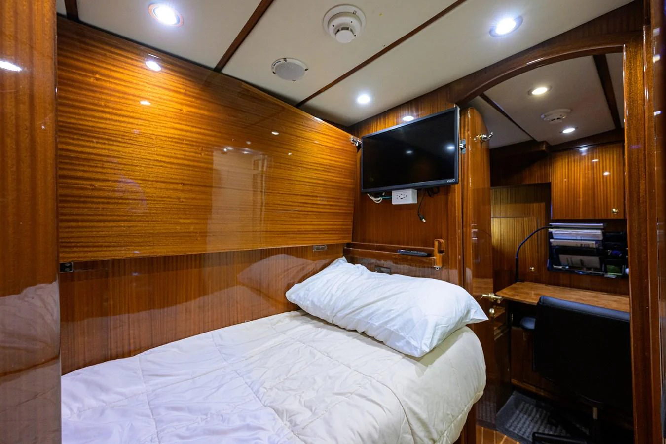 a room with a bed and a television aboard DUNIA Yacht for Sale