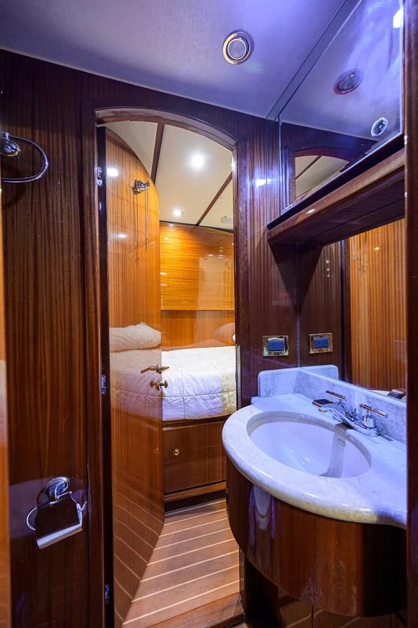 a bathroom with a sink and mirror aboard DUNIA Yacht for Sale