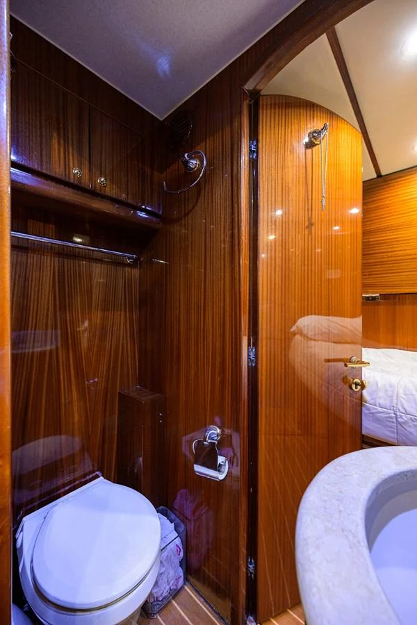 a bathroom with a toilet and sink aboard DUNIA Yacht for Sale