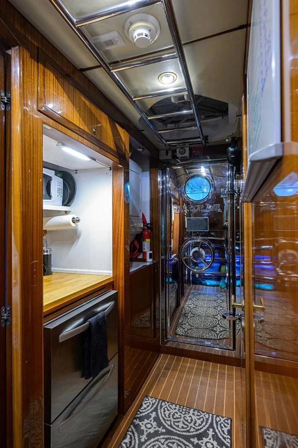 a room with a large mirror and a door aboard DUNIA Yacht for Sale