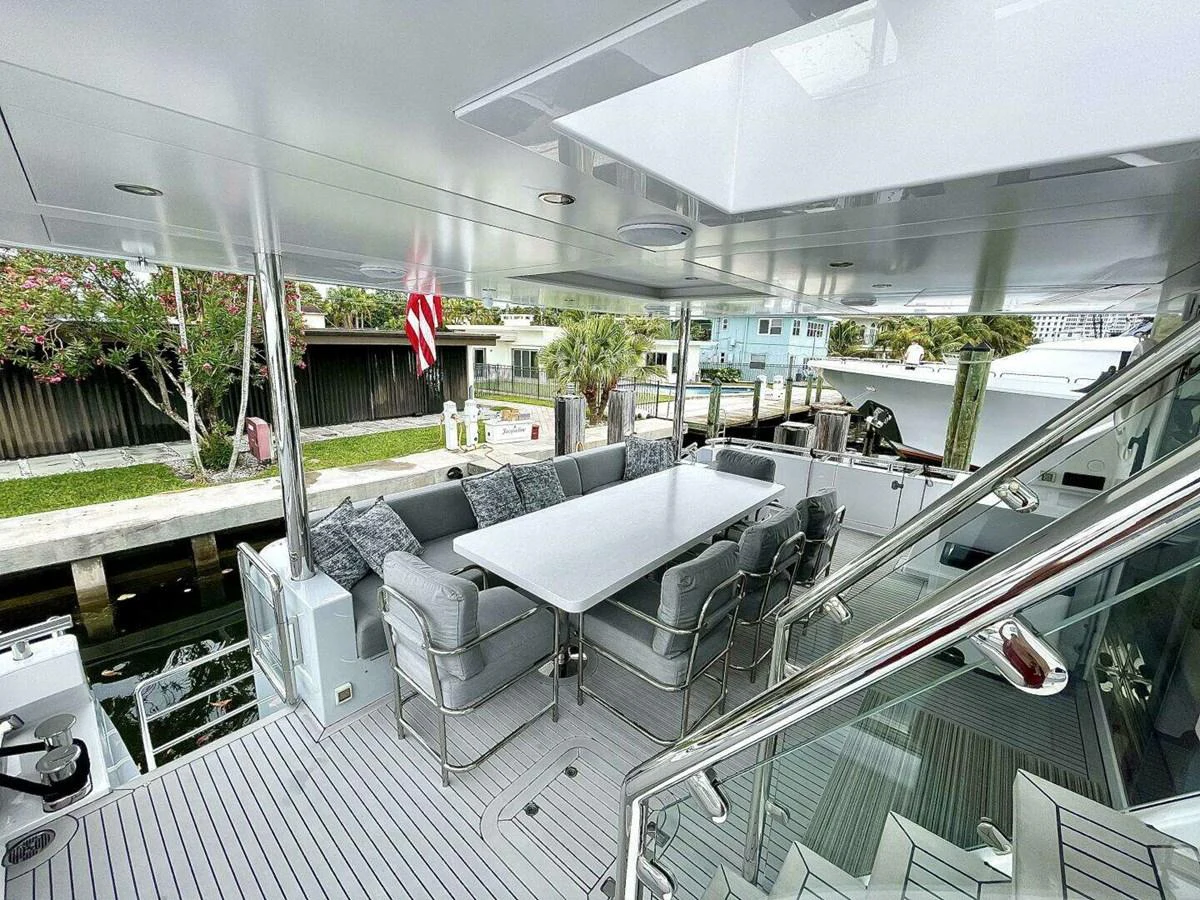 a deck with a couch and chairs aboard SCORPIO II Yacht for Sale