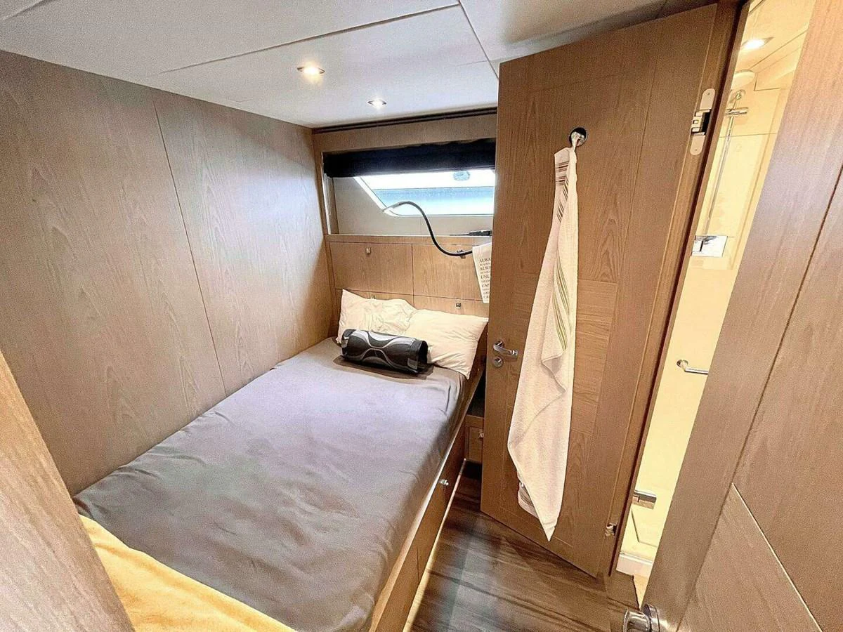 a bedroom with a bed and a closet aboard SCORPIO II Yacht for Sale