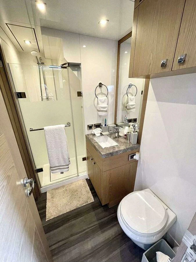 a bathroom with a toilet and a sink aboard SCORPIO II Yacht for Sale