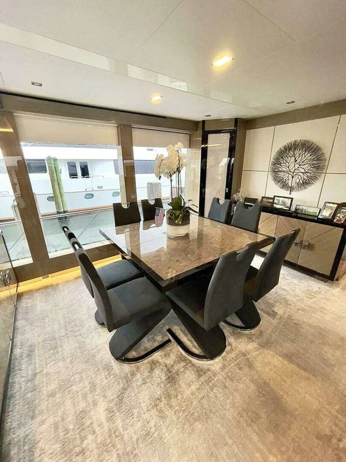 a room with a table and chairs aboard SCORPIO II Yacht for Sale