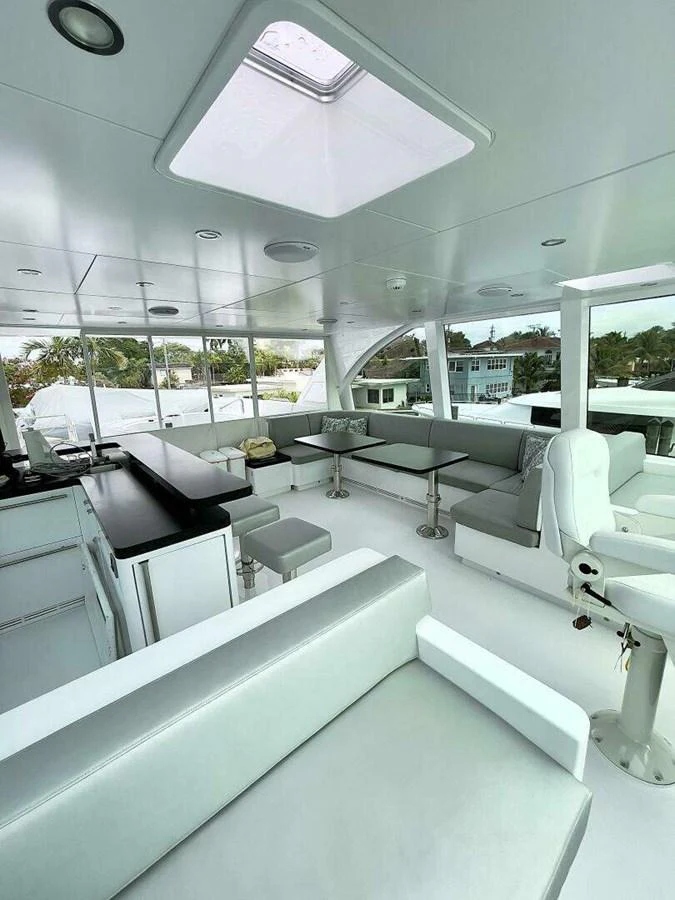 a room with tables and chairs aboard SCORPIO II Yacht for Sale