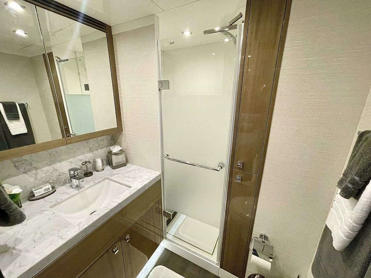 a bathroom with a glass shower door aboard SCORPIO II Yacht for Sale