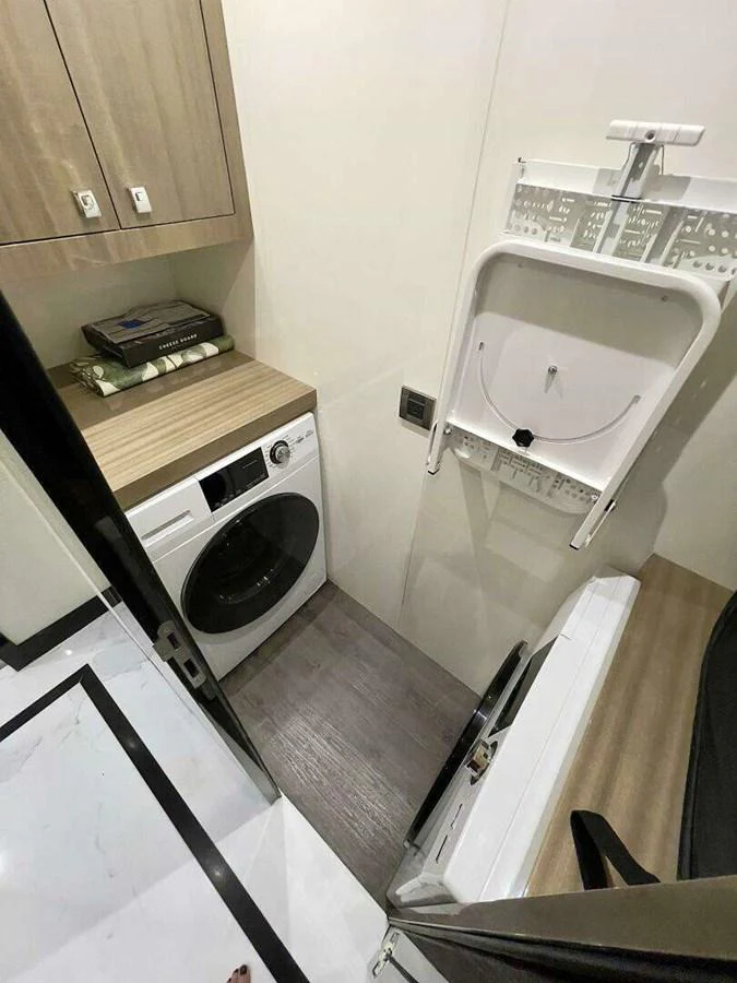 a small laundry room with a washing machine aboard SCORPIO II Yacht for Sale