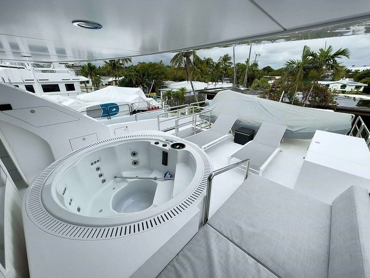 a large white car parked in a parking lot aboard SCORPIO II Yacht for Sale