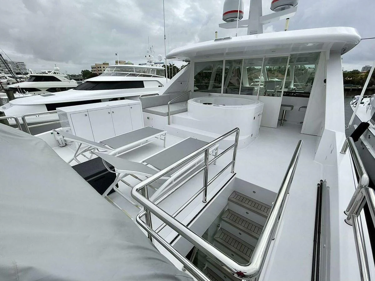 a boat with a deck and a deck with a railing and a building in the background aboard SCORPIO II Yacht for Sale