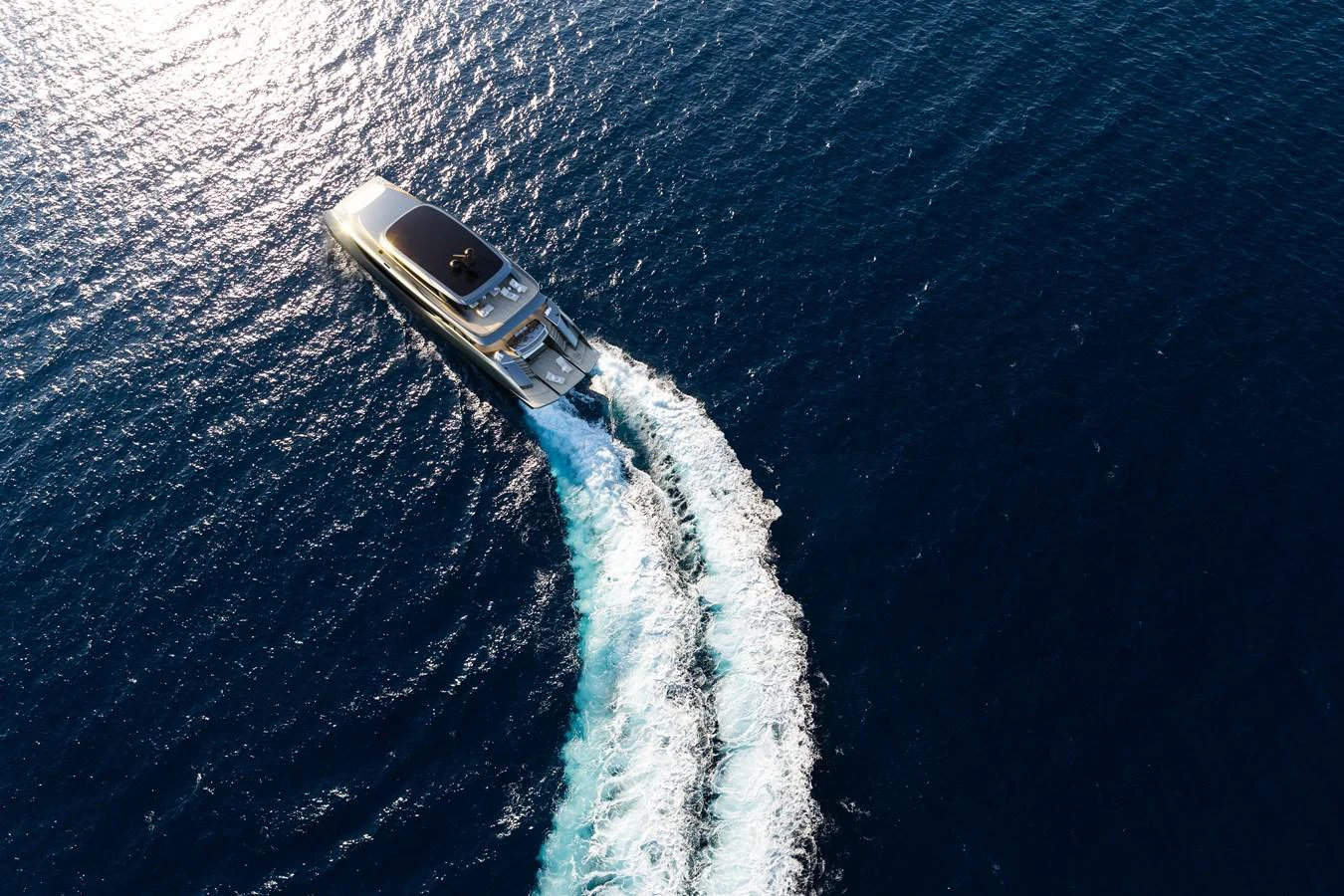 A sleek yacht cruises through the open sea, leaving a trail of white wake behind. aboard 40M SUNREEF EXPLORER ECO Yacht for Sale