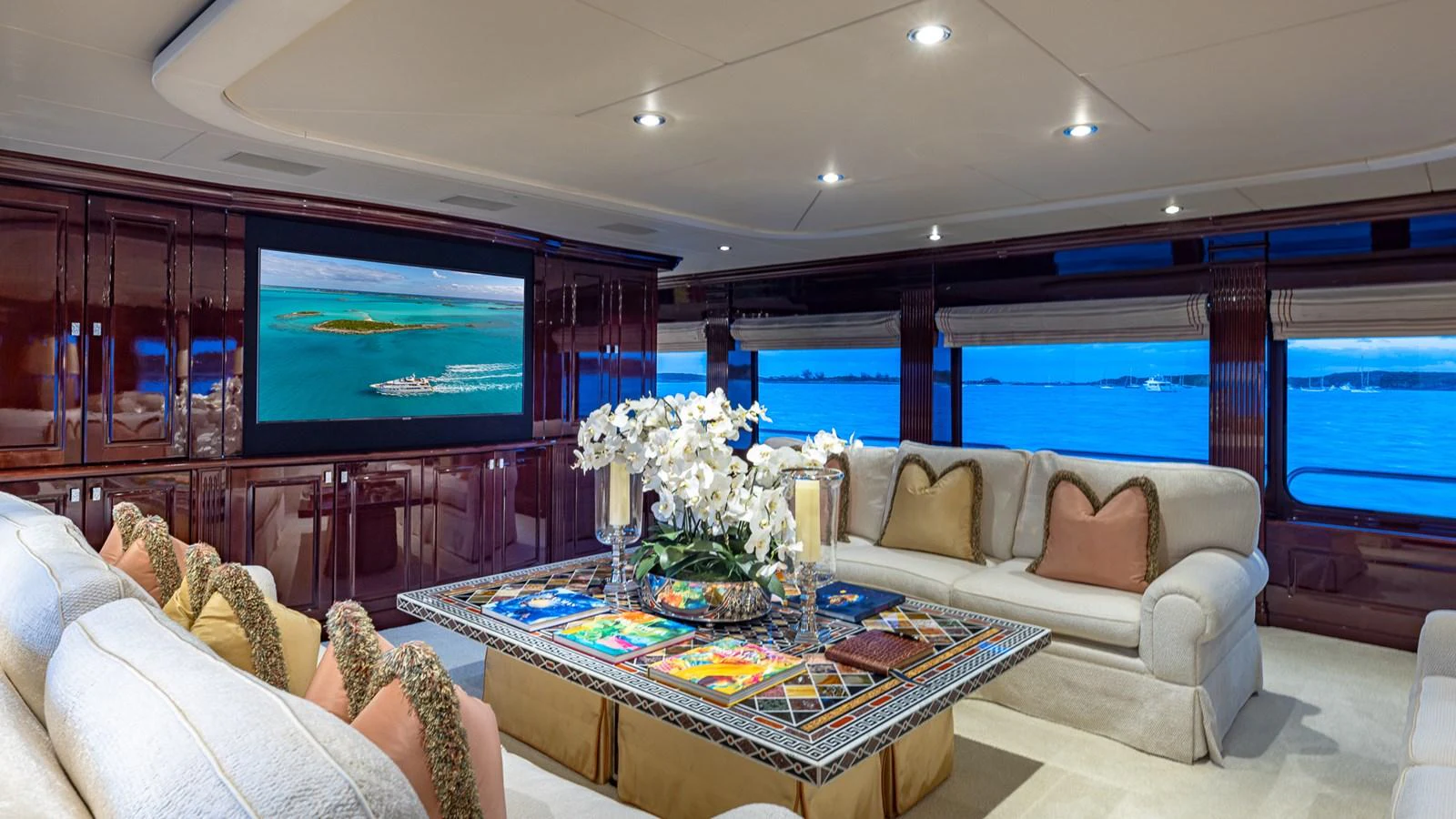 a living room with a large screen aboard LADY JOY Yacht for Sale