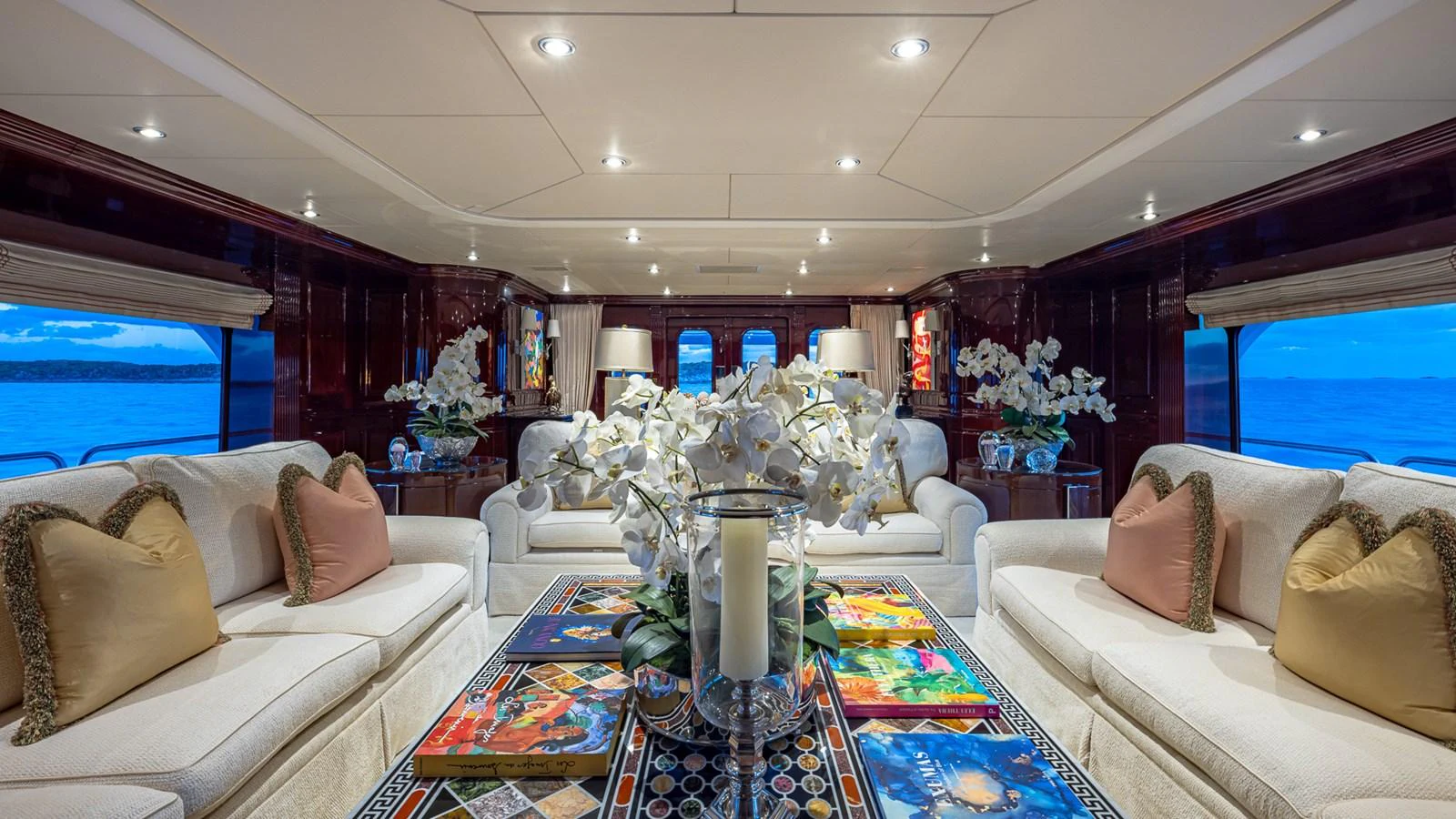 a living room with a large glass table and a large window aboard LADY JOY Yacht for Sale