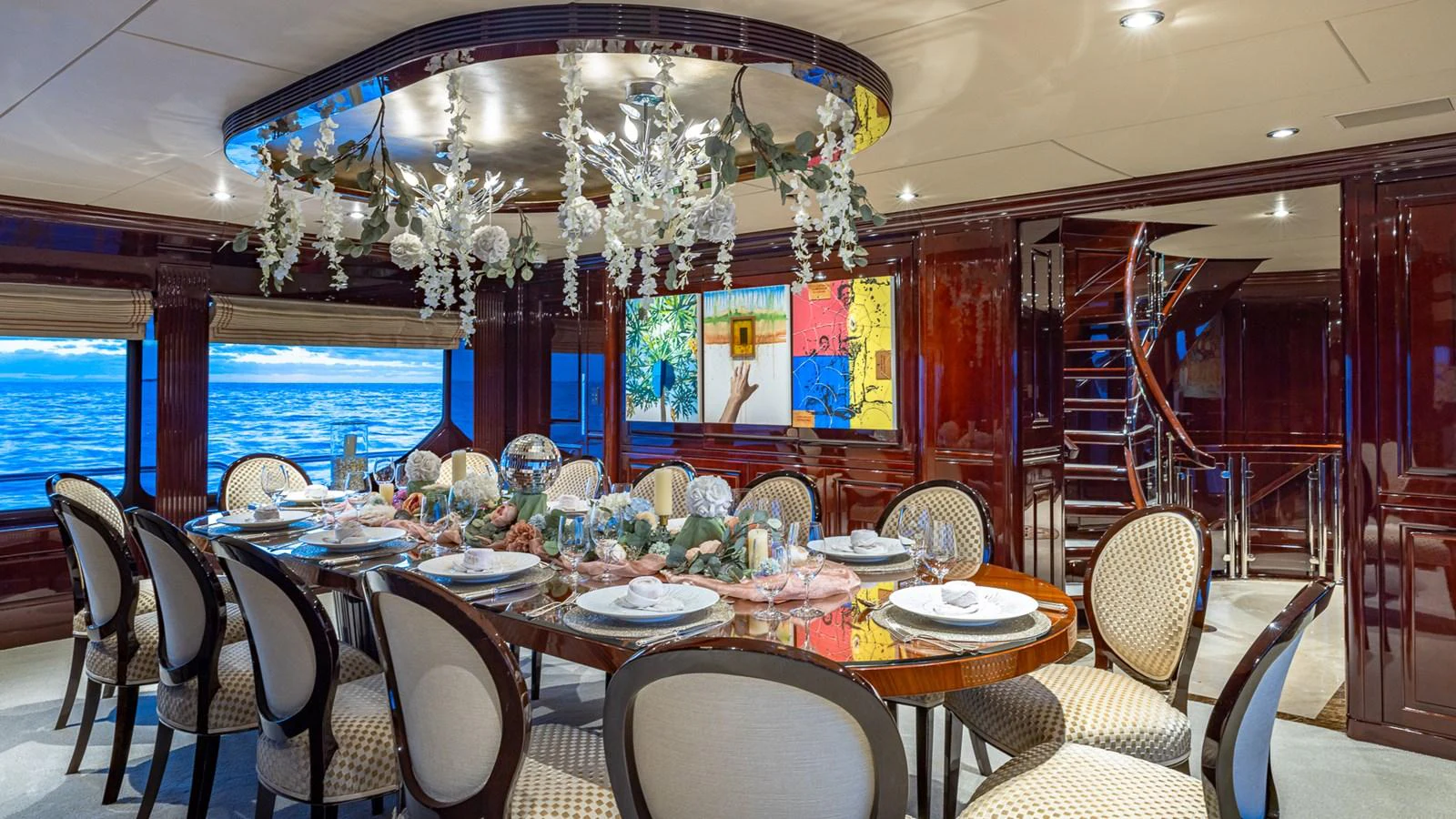 a room with tables and chairs aboard LADY JOY Yacht for Sale