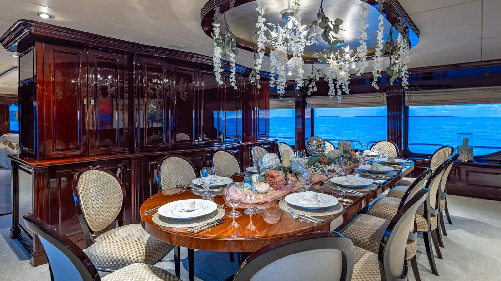 a dining room with a chandelier aboard LADY JOY Yacht for Sale