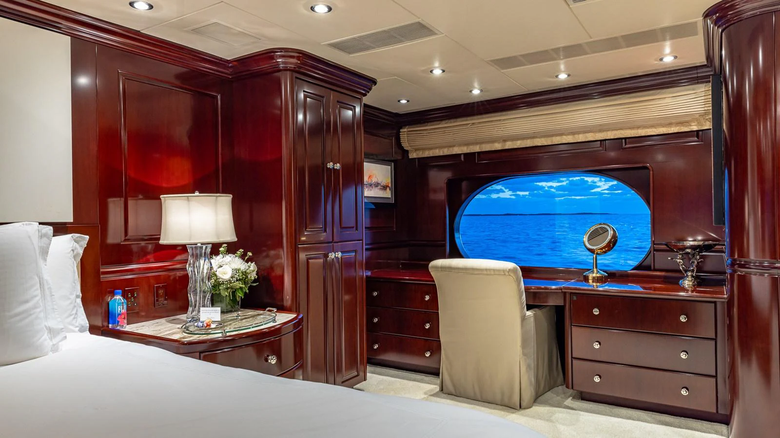 a room with a bed and a desk aboard LADY JOY Yacht for Sale