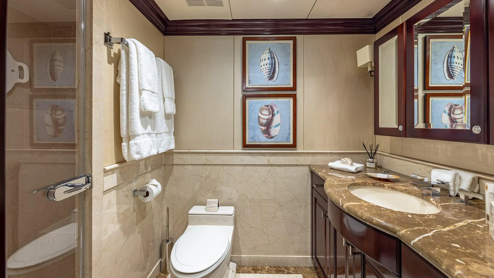 a bathroom with a sink toilet and a mirror aboard LADY JOY Yacht for Sale