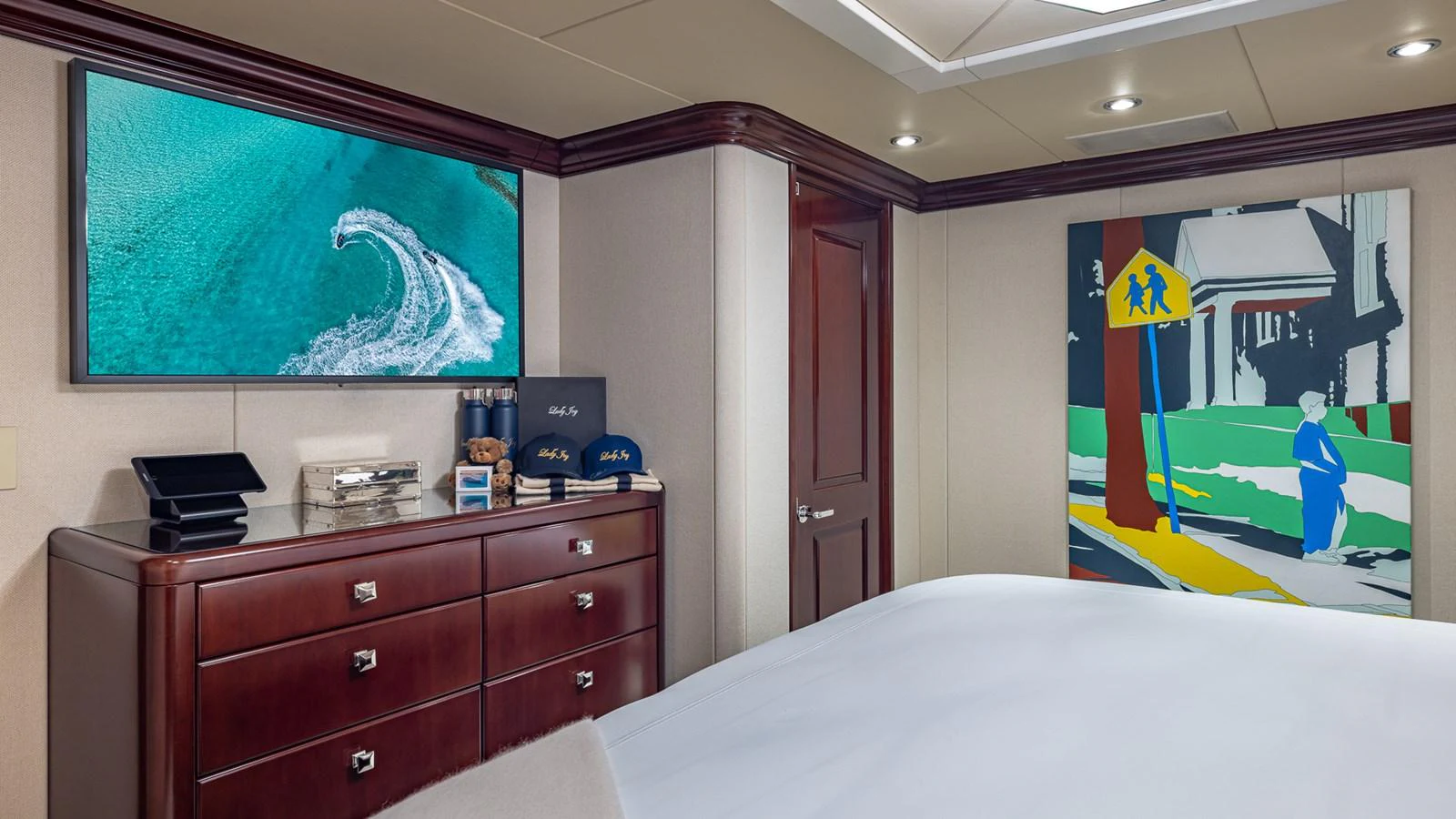 a bedroom with a large screen aboard LADY JOY Yacht for Sale