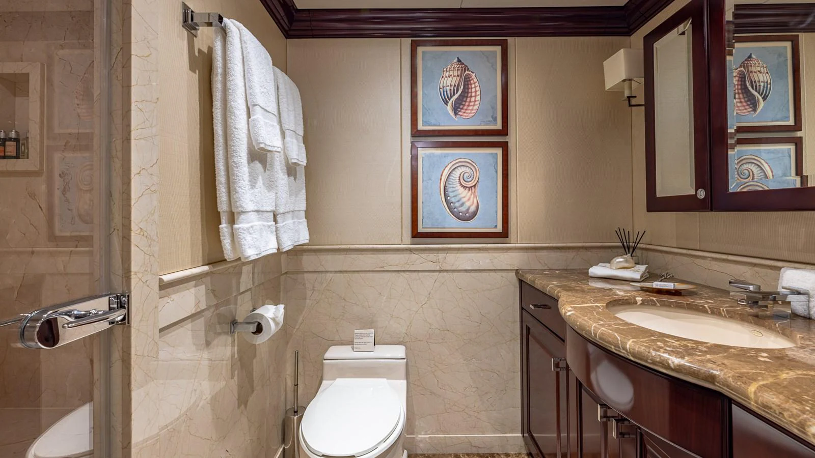 a bathroom with a sink toilet and a mirror aboard LADY JOY Yacht for Sale