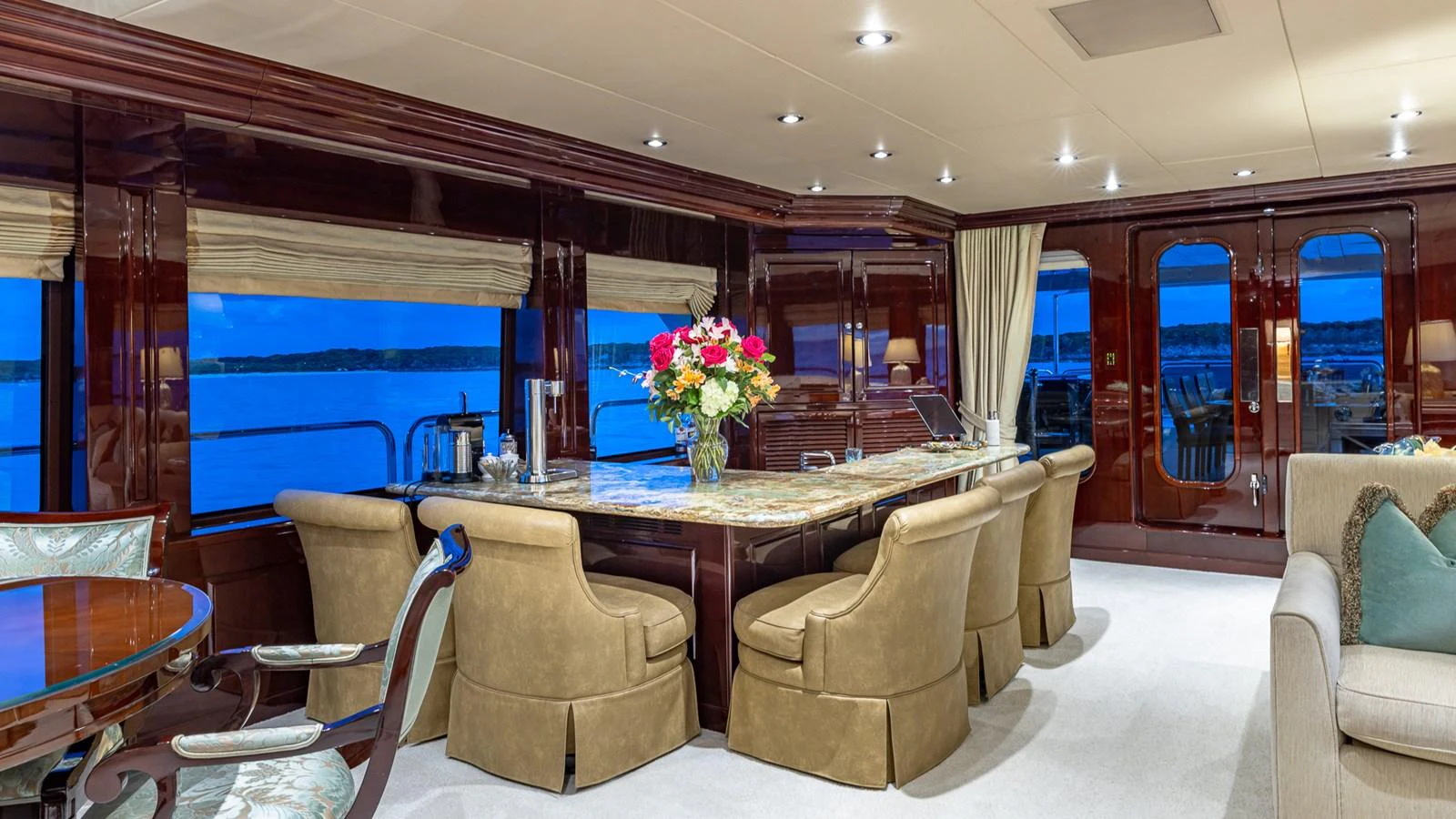 a large room with a table and chairs aboard LADY JOY Yacht for Sale