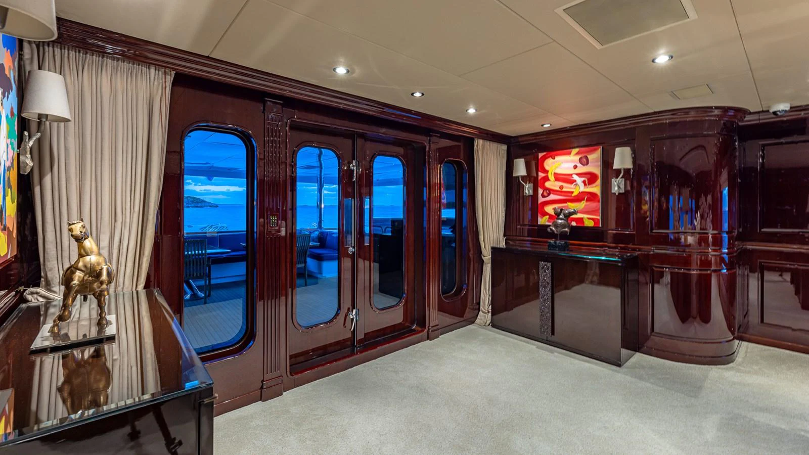 a room with a glass door and a statue of a dog in it aboard LADY JOY Yacht for Sale