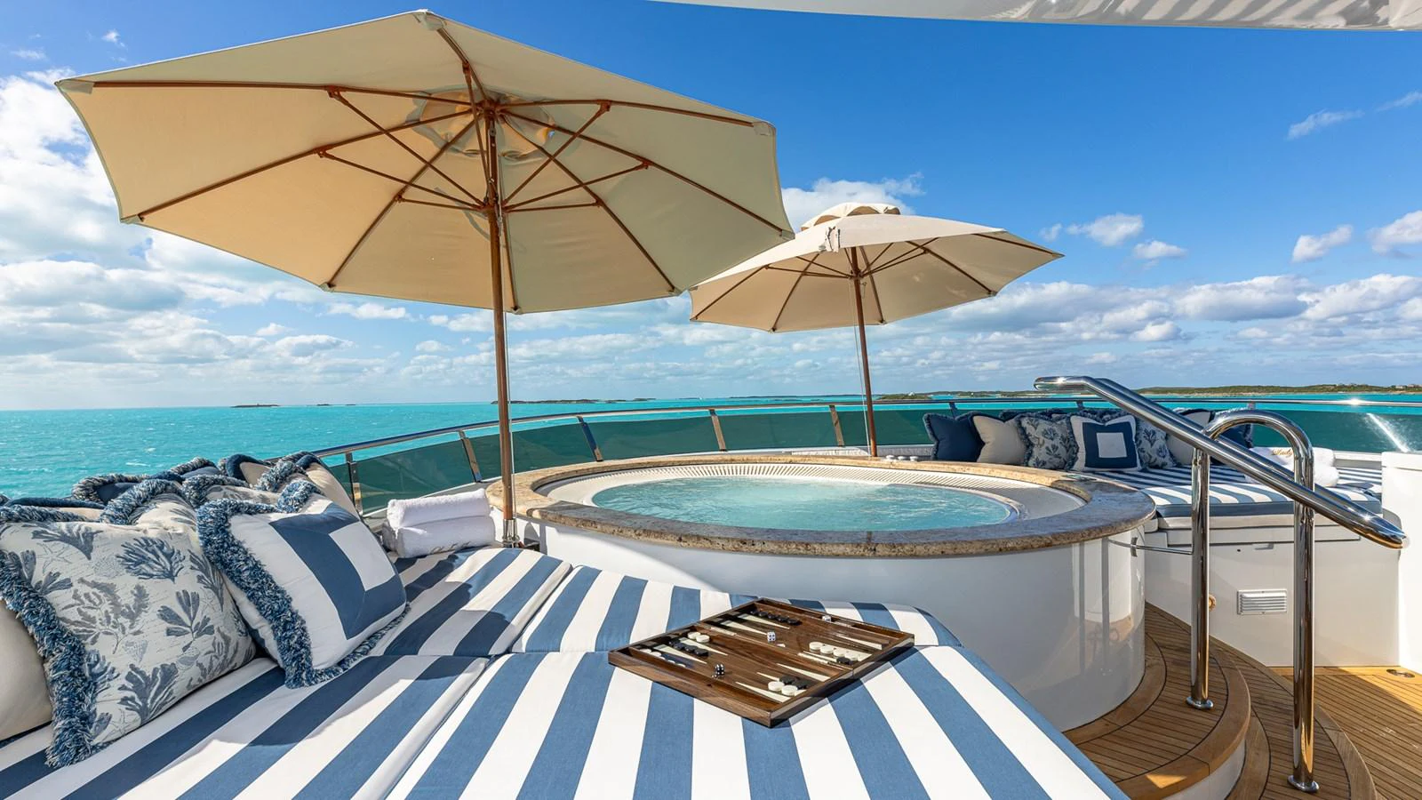 a pool with a table and umbrella aboard LADY JOY Yacht for Sale
