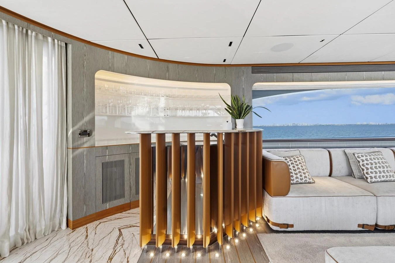 a room with a wood railing and a white couch and a white wall aboard WILD DUCK Yacht for Sale