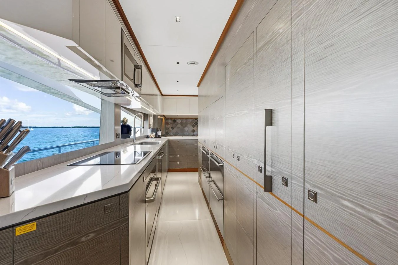 a long hallway with glass doors aboard WILD DUCK Yacht for Sale