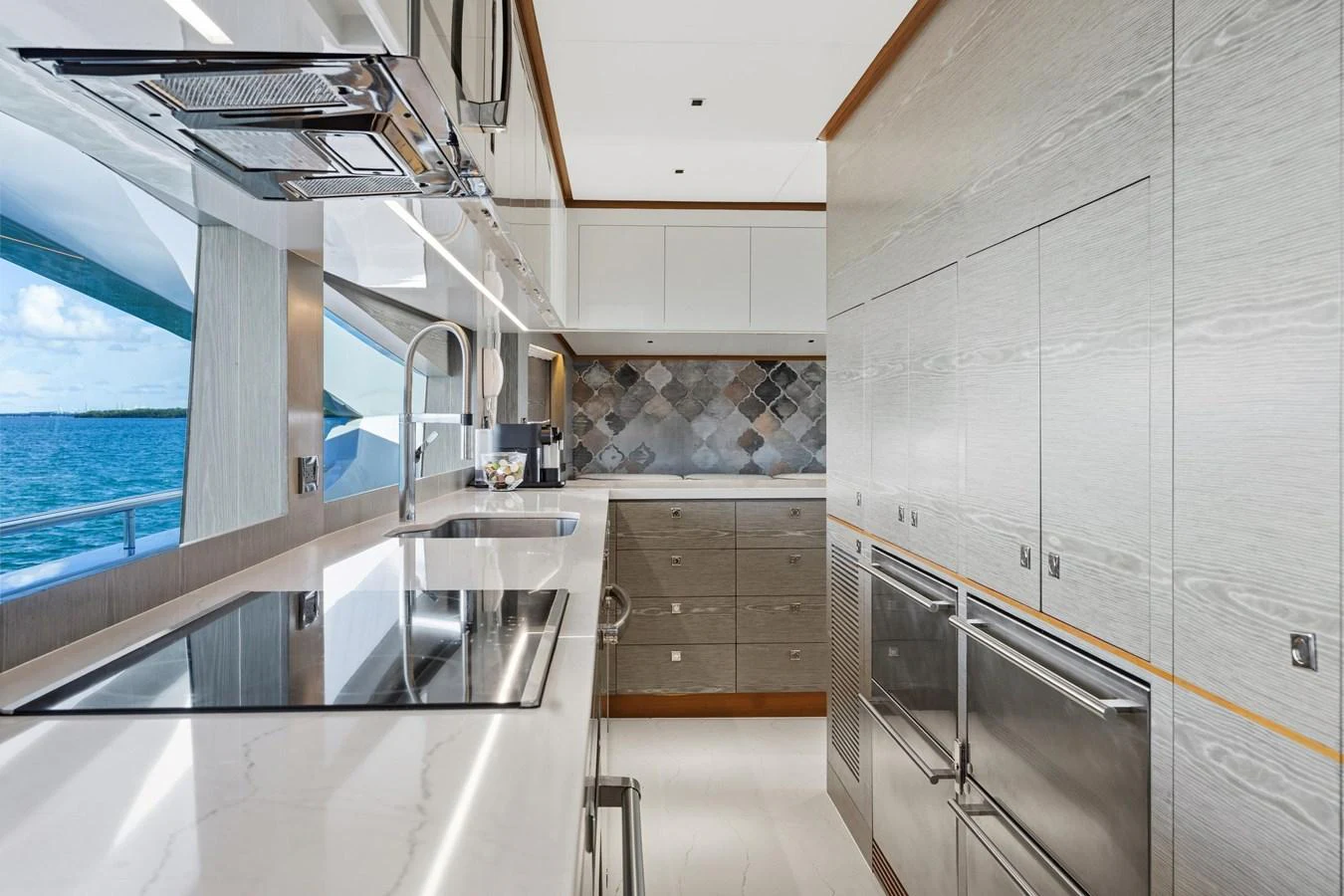 a kitchen with a glass wall aboard WILD DUCK Yacht for Sale