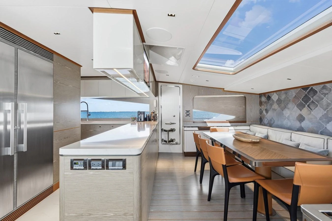 a kitchen with a table and chairs aboard WILD DUCK Yacht for Sale