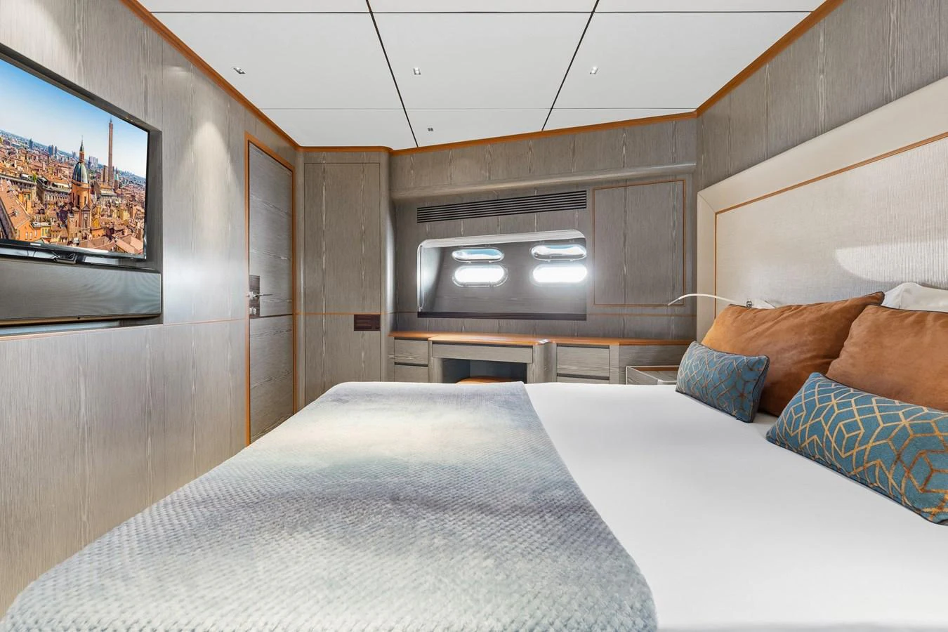 a bed with a television on the wall aboard WILD DUCK Yacht for Sale