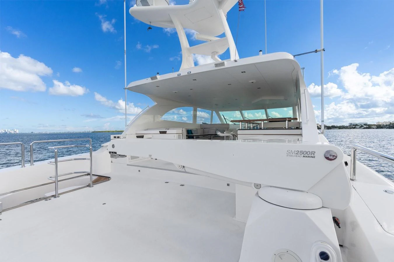a white boat on a beach aboard WILD DUCK Yacht for Sale
