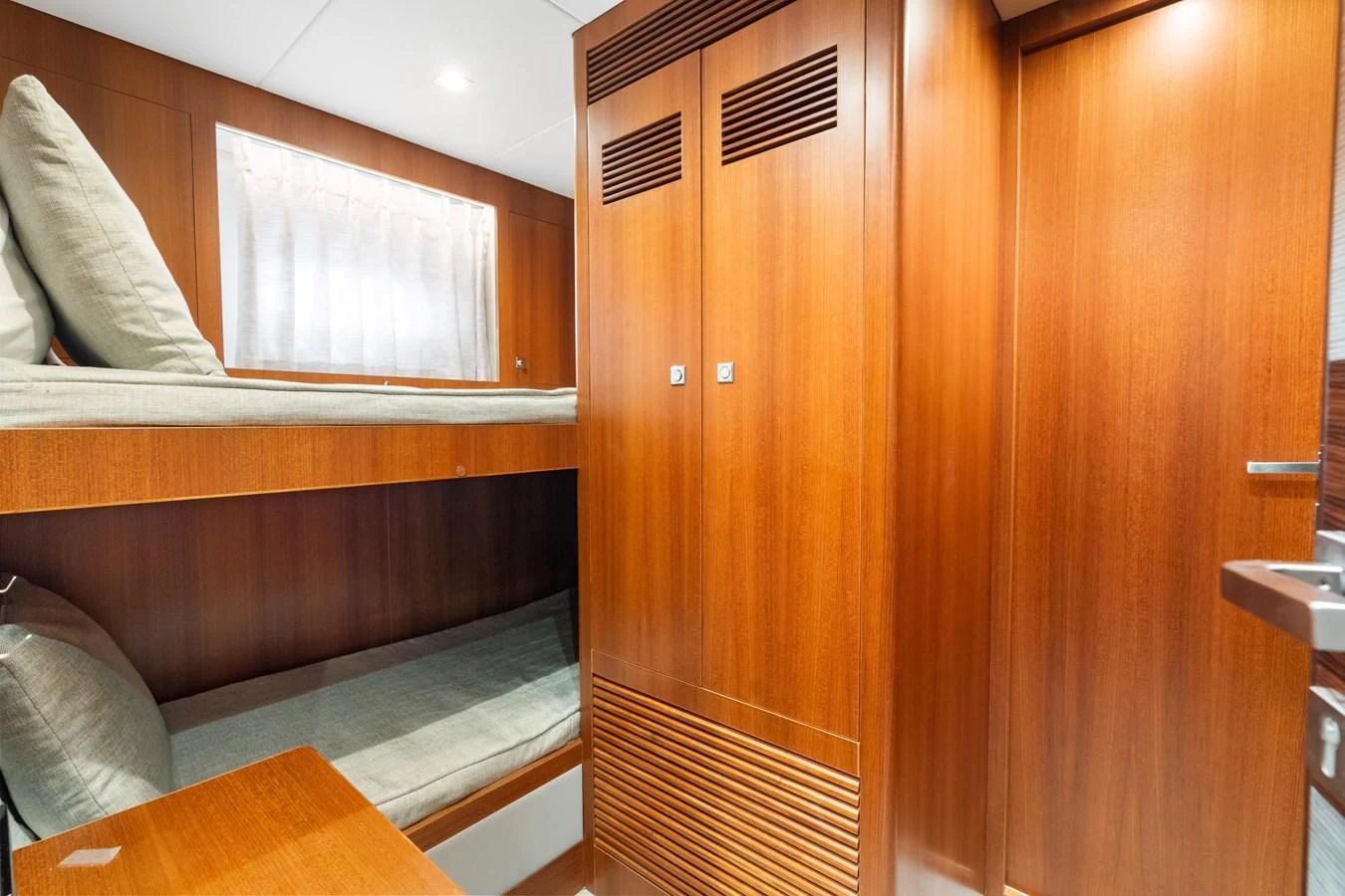 a room with a couch and a wood door aboard WILD DUCK Yacht for Sale