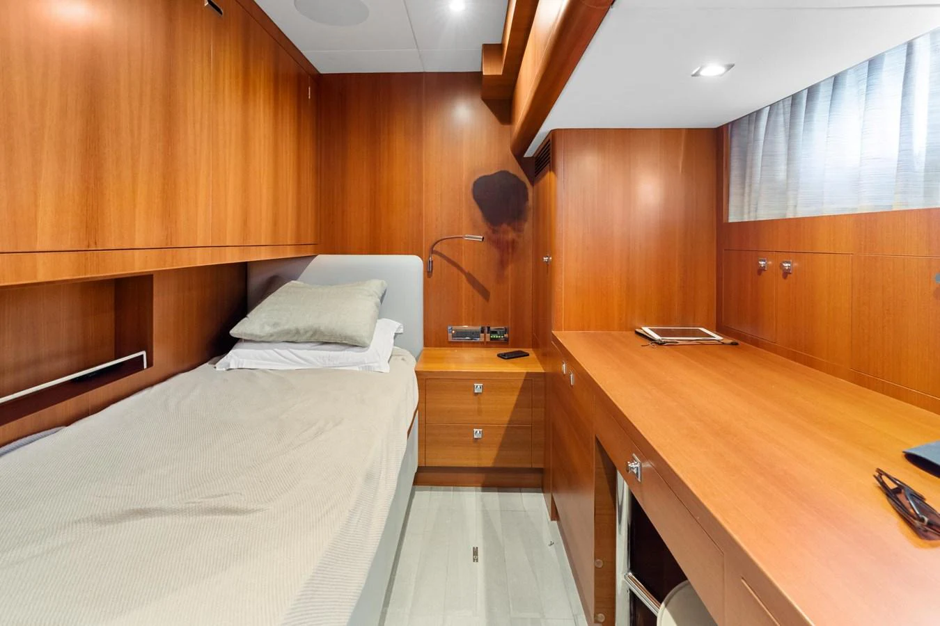 a bedroom with a bed and a desk aboard WILD DUCK Yacht for Sale