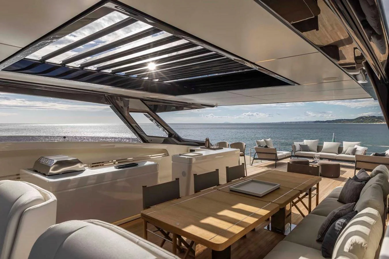 The aft deck offers a luxurious outdoor dining and lounging area with stunning ocean views. aboard EPIC Yacht for Sale