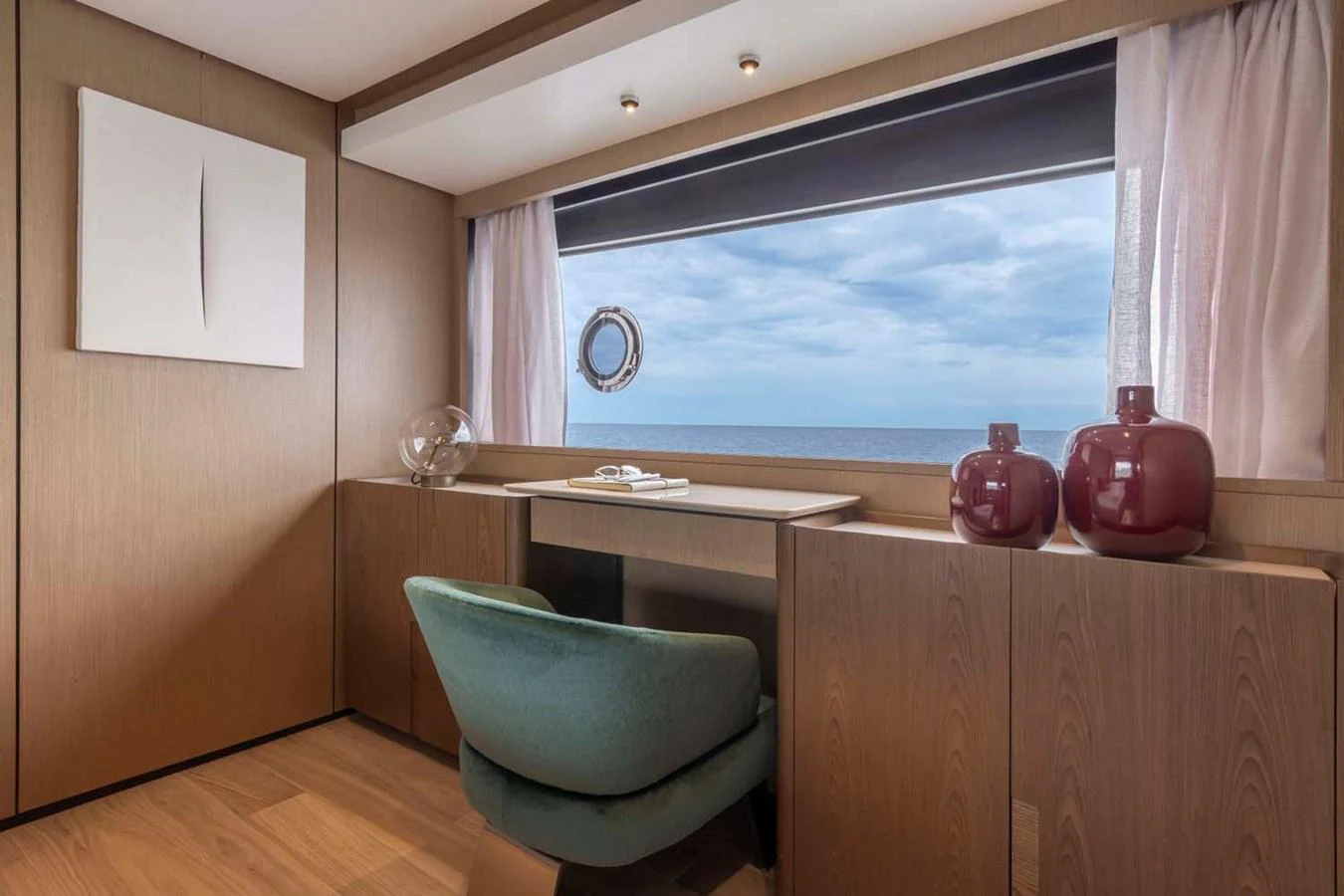 A serene office space with a large window offering a stunning ocean view. aboard EPIC Yacht for Sale