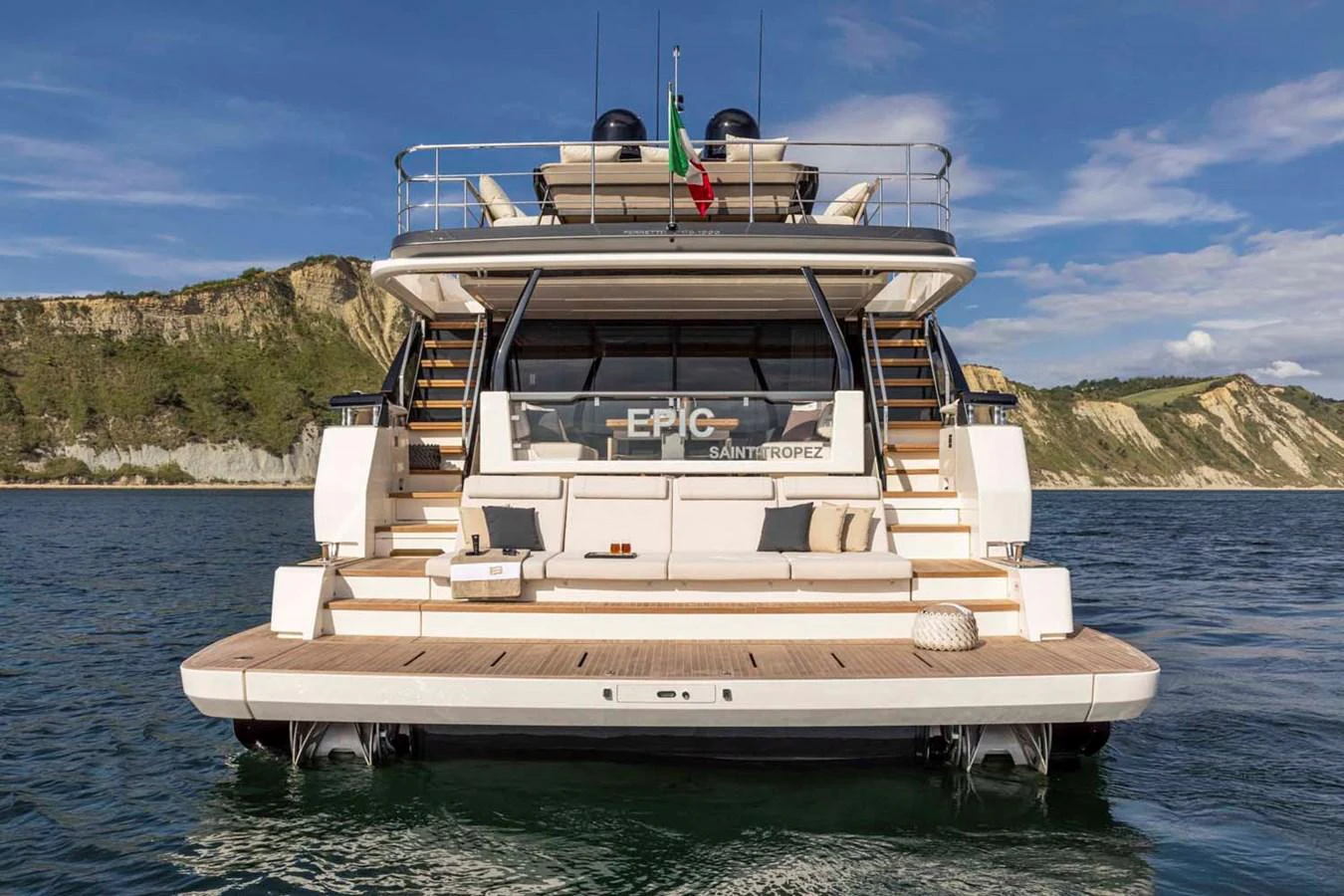 The yacht's aft deck features a spacious lounging area with elegant seating and scenic views. aboard EPIC Yacht for Sale