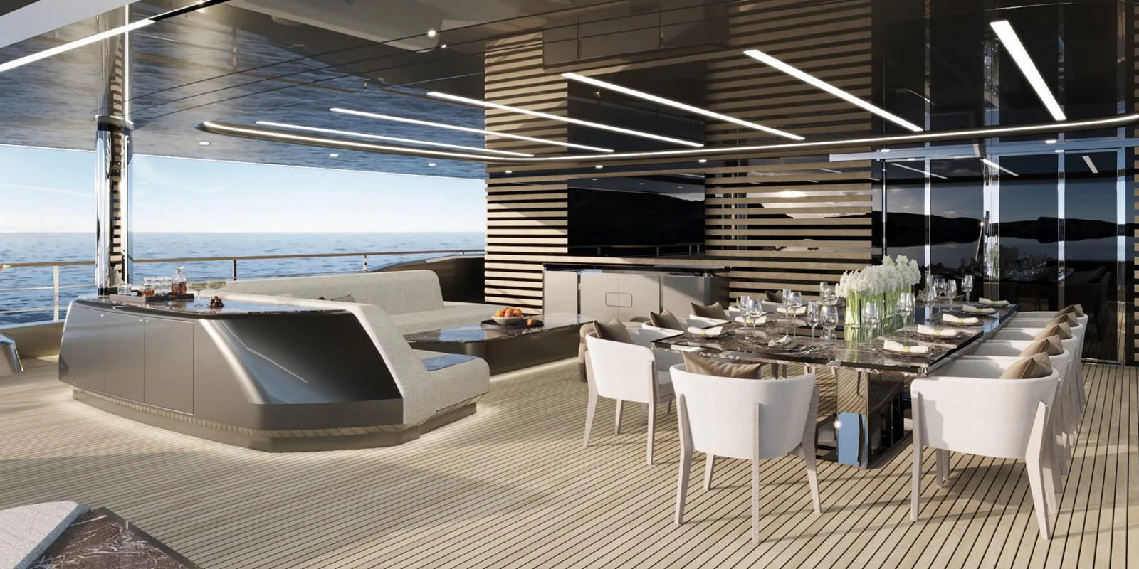 The aft deck features a luxurious dining area with a stunning ocean view. aboard 45M SUNREEF EXPLORER Yacht for Sale