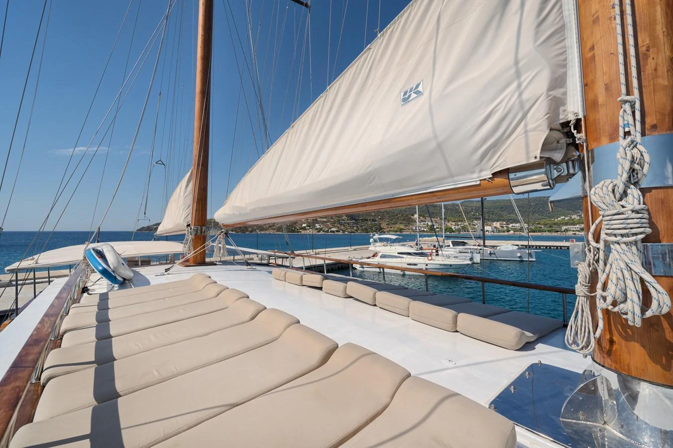 The yacht's deck features comfortable sun loungers and a stunning view of the surrounding waters. aboard THALASSA Yacht for Sale
