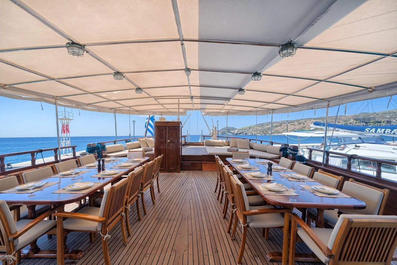 This spacious alfresco dining area offers a luxurious setting for enjoying meals with a stunning ocean view. aboard THALASSA Yacht for Sale