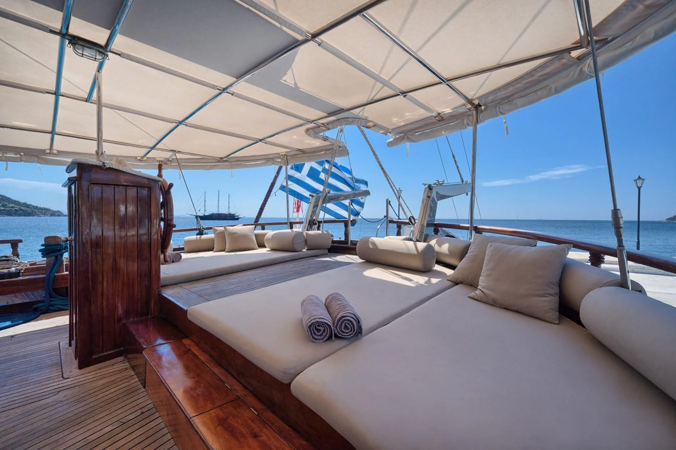 The sundeck offers a spacious and comfortable lounging area with plush cushions and a shaded canopy, perfect for relaxation. aboard THALASSA Yacht for Sale