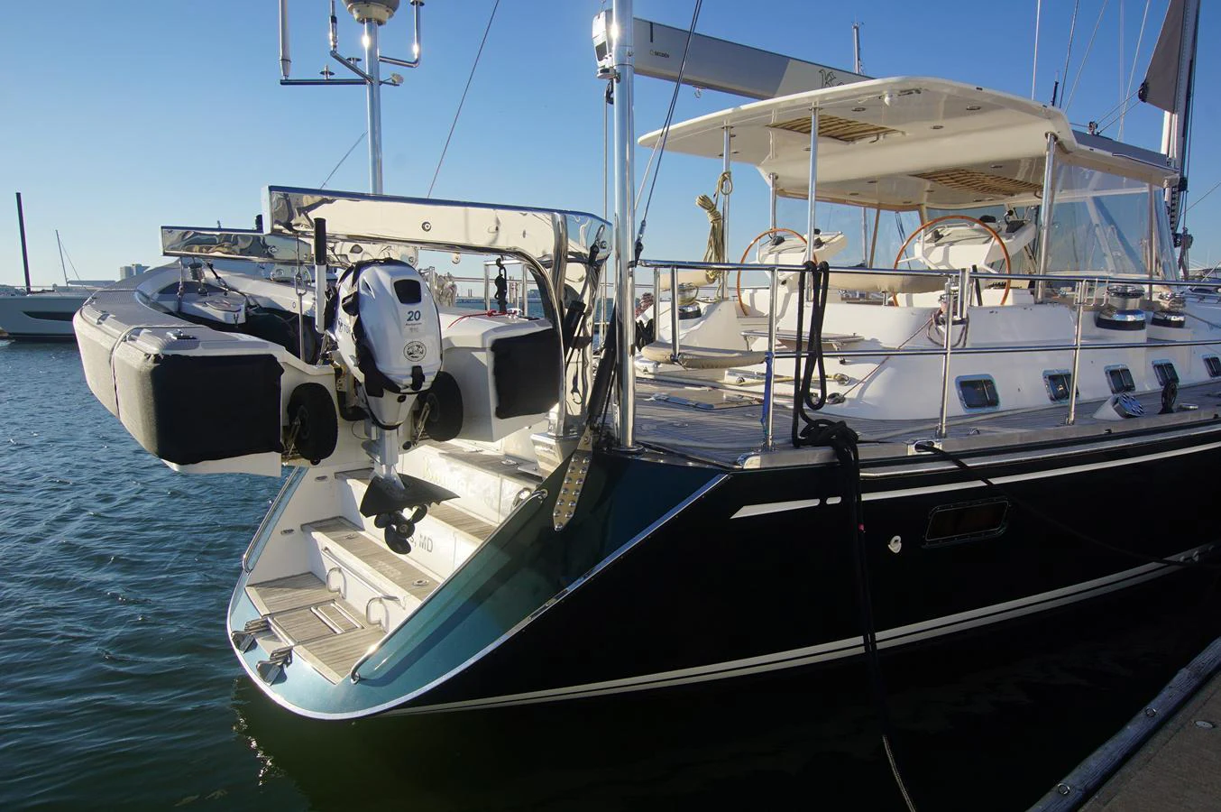 A sleek yacht docked at the marina, showcasing its elegant design and well-equipped stern. aboard RAGNAR Yacht for Sale