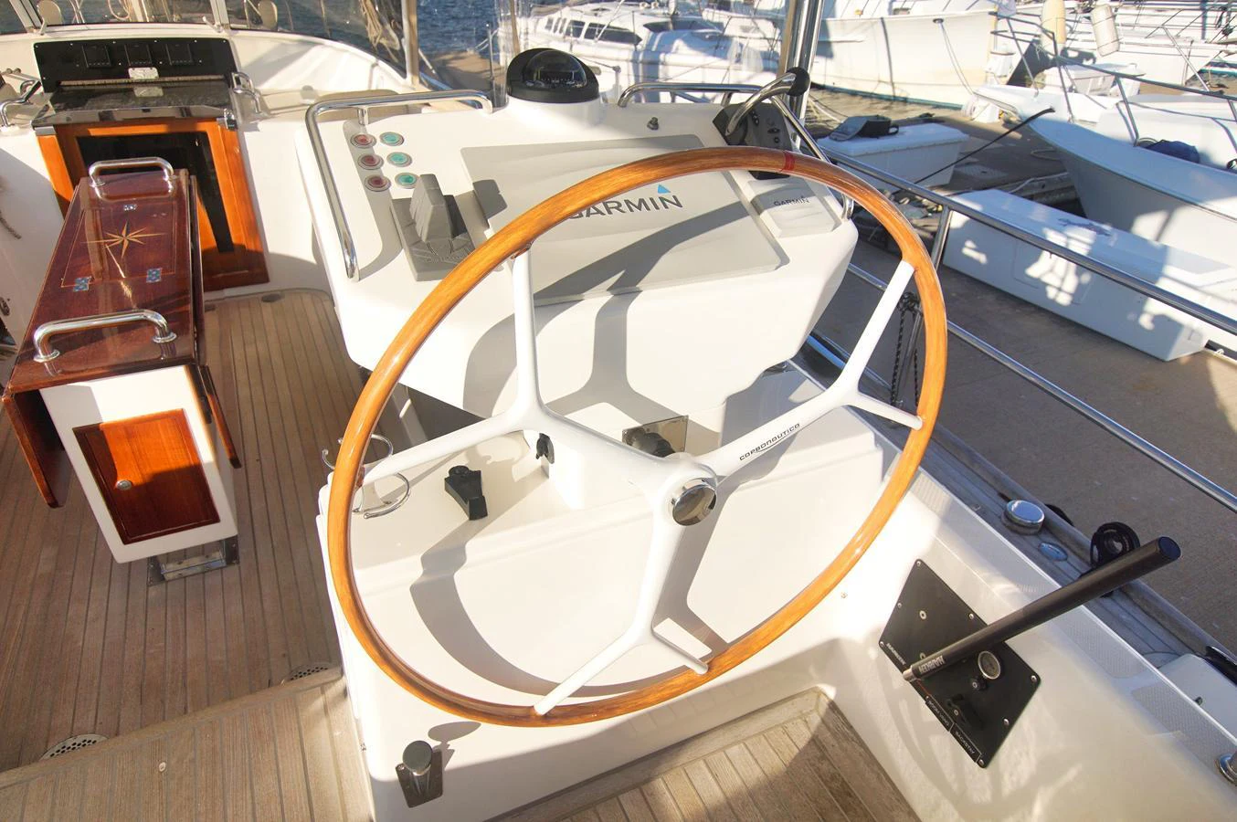The helm station features a classic wooden steering wheel and modern navigation equipment. aboard RAGNAR Yacht for Sale