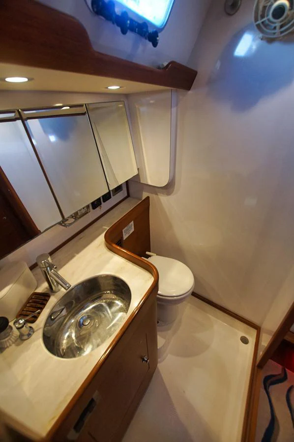 A compact and well-appointed yacht head with modern fixtures and a sleek design. aboard RAGNAR Yacht for Sale