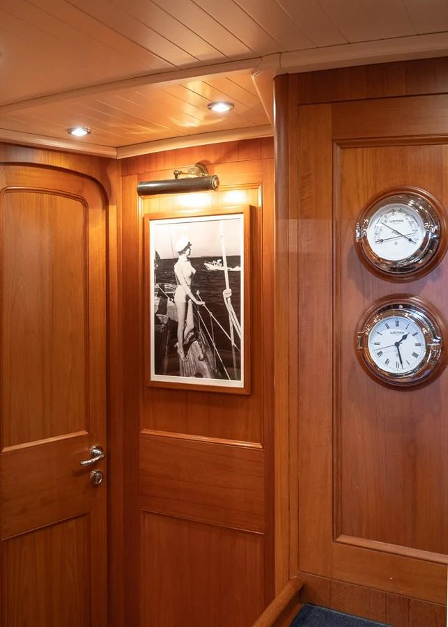 The yacht's interior features warm wooden paneling and nautical decor. aboard TEMPEST Yacht for Sale