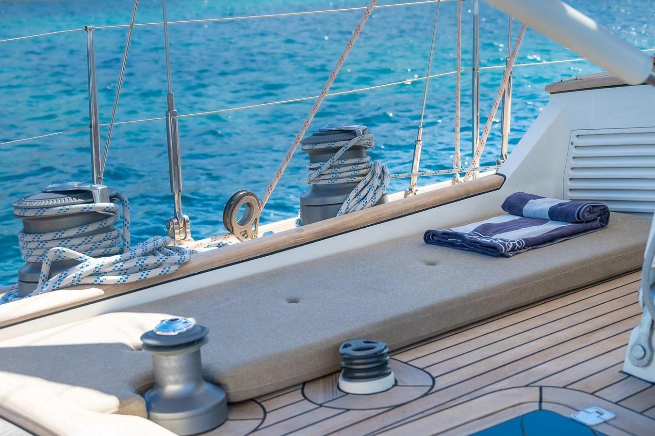 A close-up view of the yacht's deck with neatly coiled ropes and a folded towel, showcasing attention to detail and craftsmanship. aboard TEMPEST Yacht for Sale